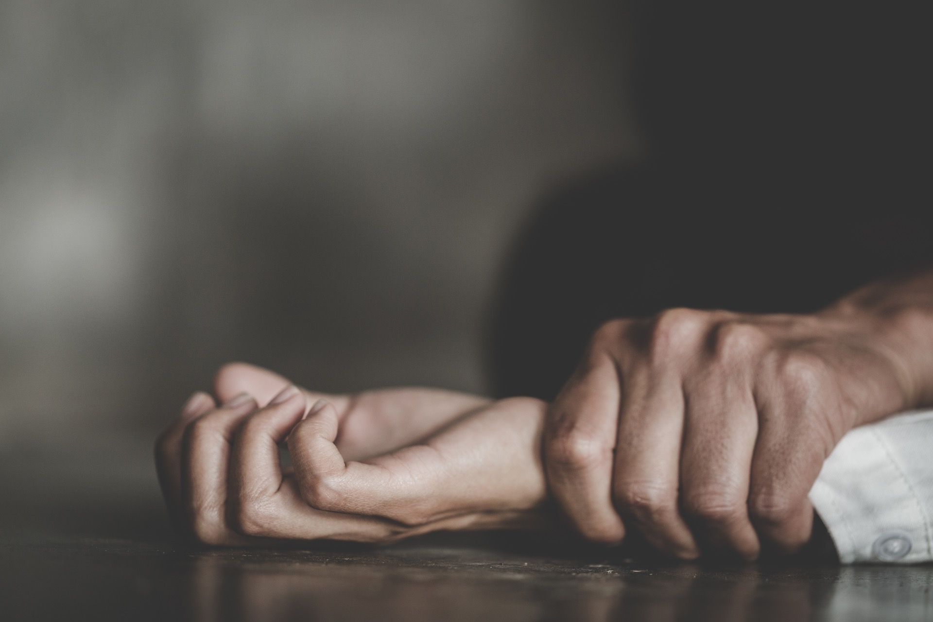 Person grabbing someone violently